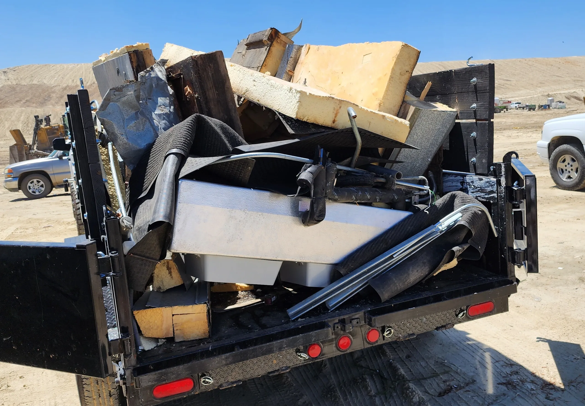 A dumpster full of junk is parked in line at the Bakersfield dump
