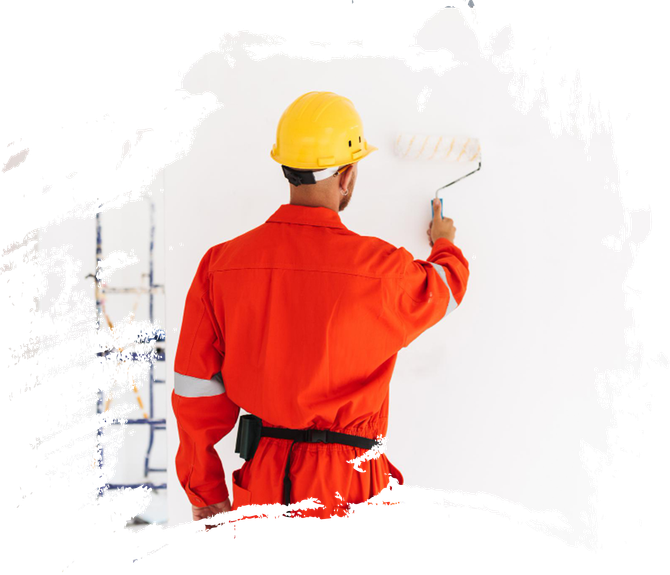 A man in a hard hat is painting a wall with a paint roller.