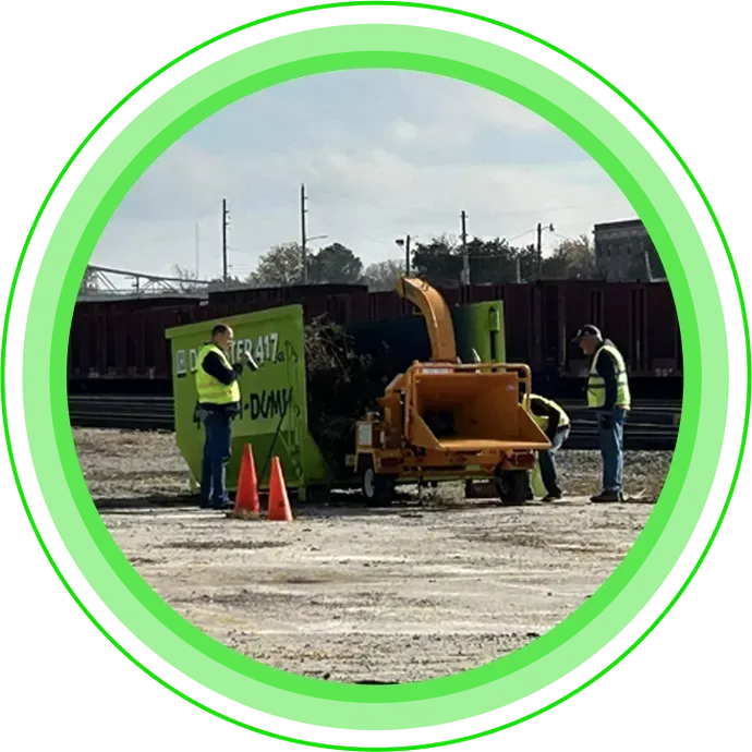 crew loading debris into green Dumpster417 rental Springfield MO
