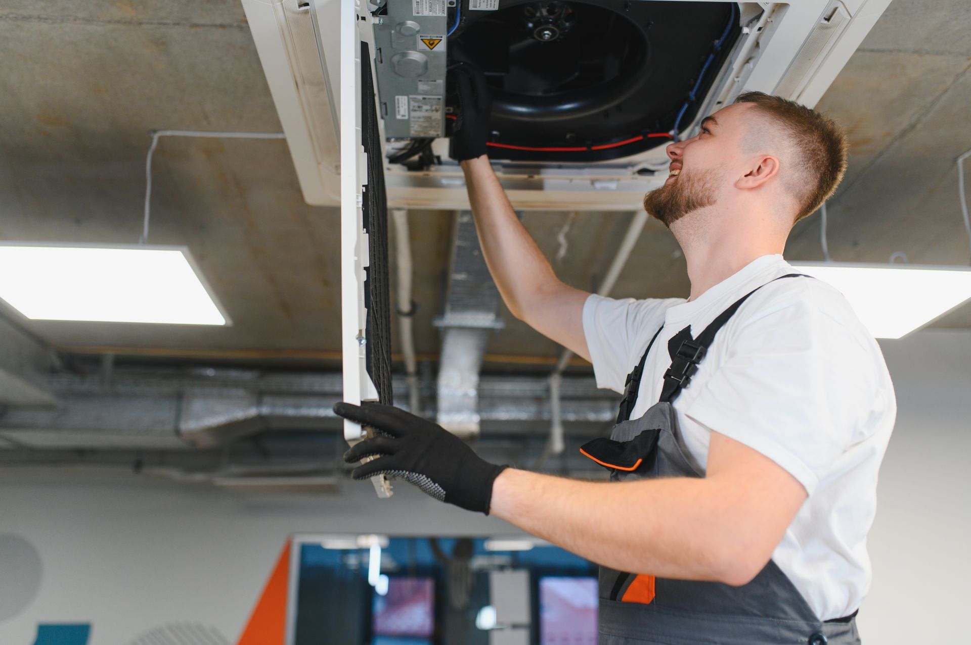 Schiller technician connecting HEPA vacuum equipment to ductwork access point