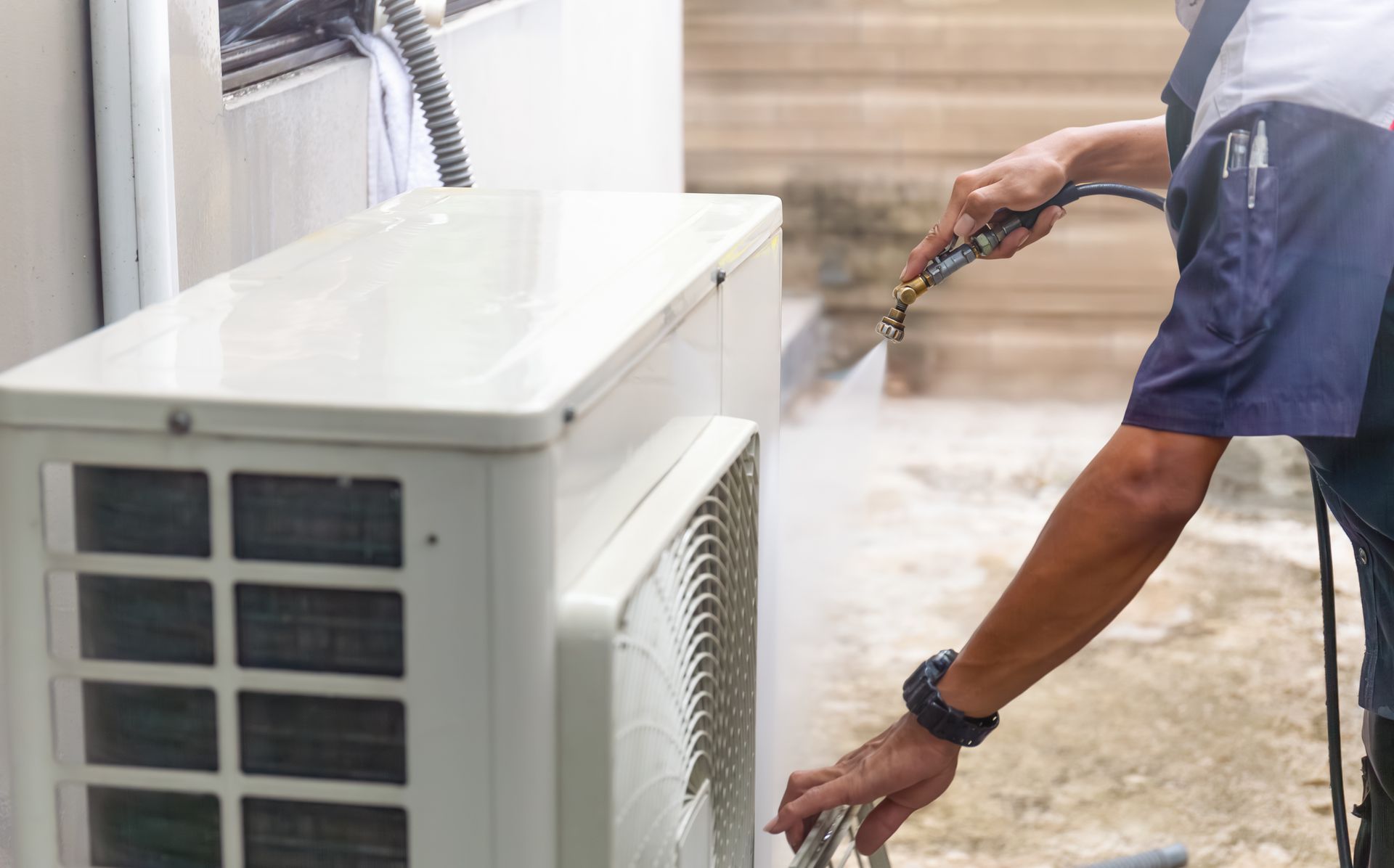 Schiller technician connecting HEPA vacuum equipment to ductwork access point