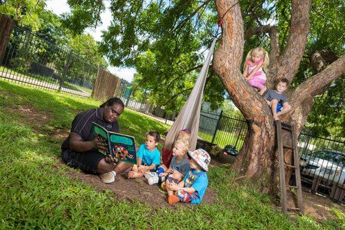 Woman Reading a Book with Kids — Darwin, NT — Territory Child Care Group