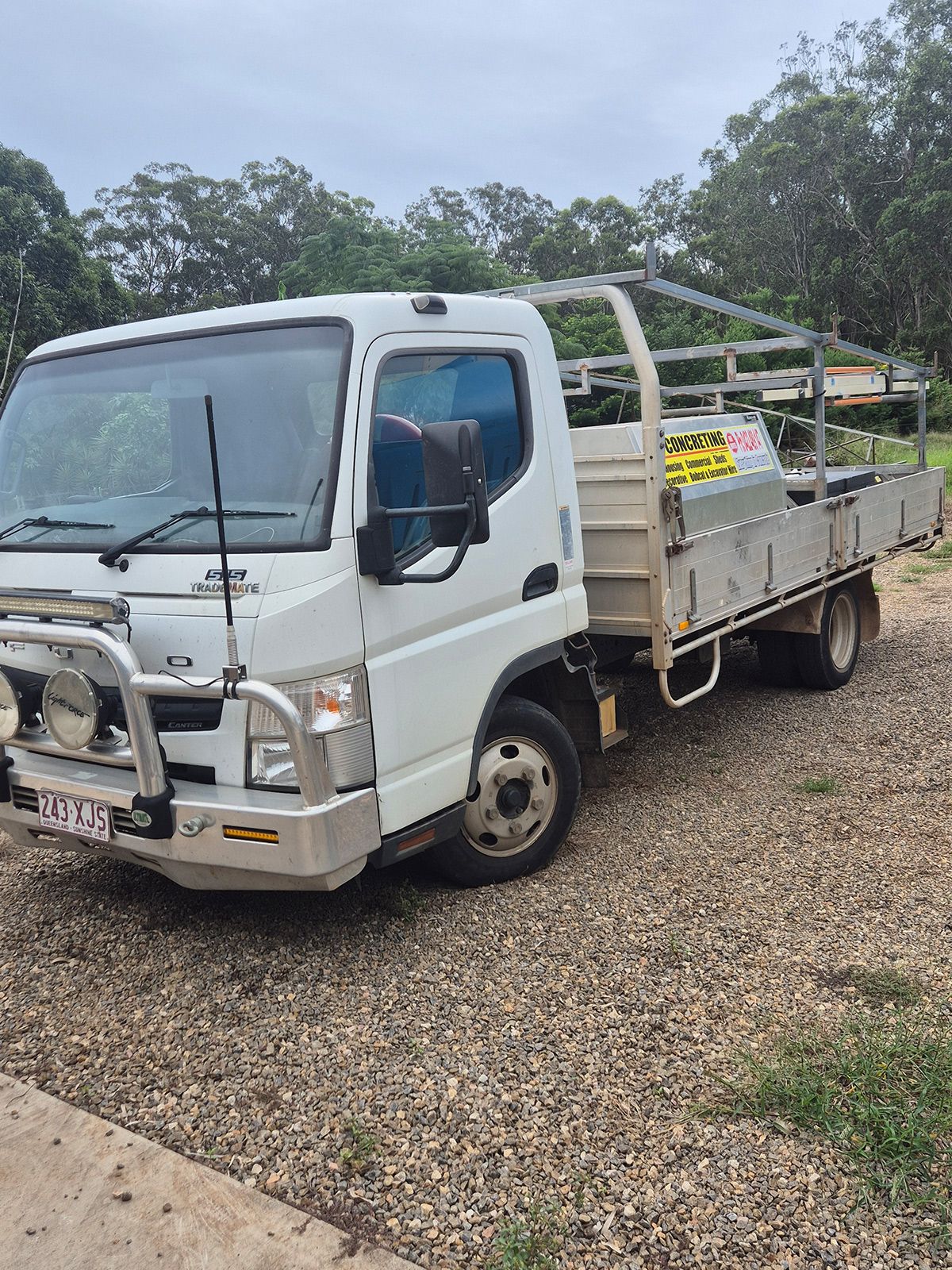 White Flatbed Utility Truck Parked on Gravel — TP Concreting In Warilla, NSW