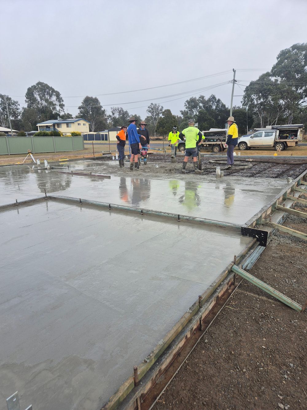 Construction Workers Smoothing a Wet Concrete Slab — TP Concreting In Nanango, QLD