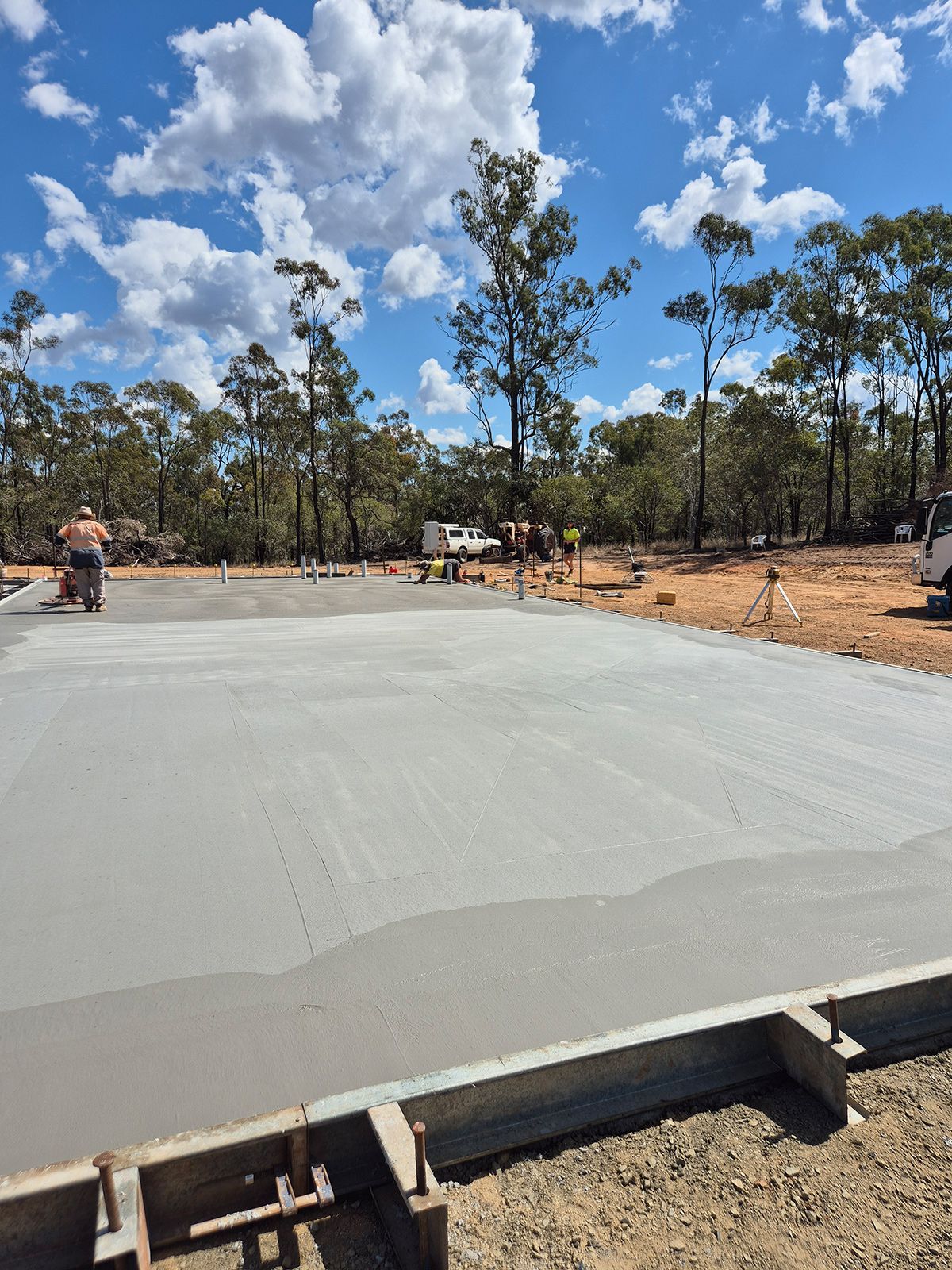 Fresh Concrete Slab at a Construction Site Under a Blue Sky — TP Concreting In Warilla, NSW