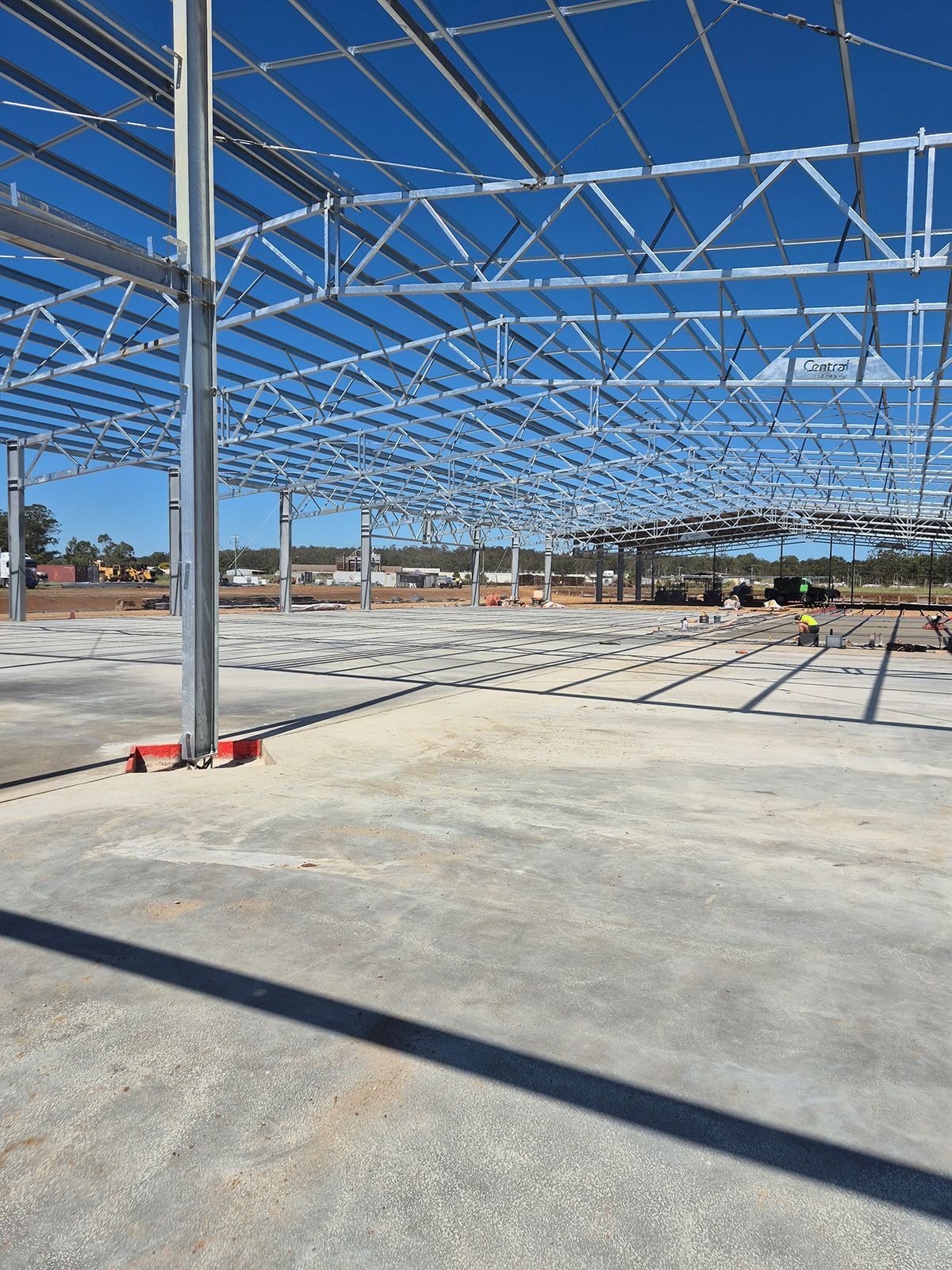 Steel Frame Building Under Construction on a Concrete Slab— TP Concreting In Dapto, NSW