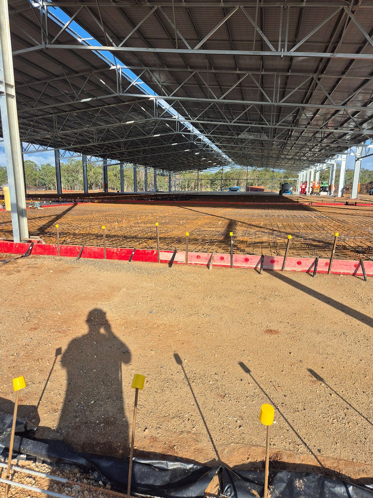 Open-sided Pavilion With Concrete Floor, Red Barrier Tape, and a Shadow — TP Concreting In Warilla, NSW