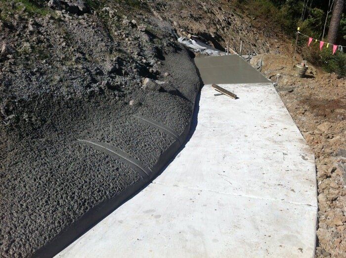 A Concrete Wall Is Being Built On The Side Of A Hill — TP Concreting In Warilla, NSW