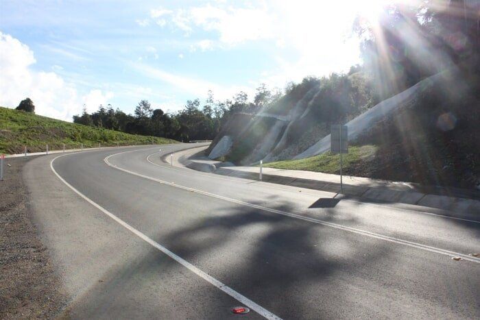 The Sun Is Shining Through The Trees On The Side Of The Road — TP Concreting In Warilla, NSW
