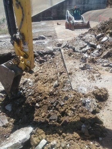 A Bulldozer Is Digging A Hole In The Ground — TP Concreting In Kingaroy, QLD