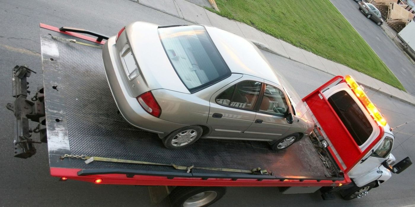 A car is being towed by a tow truck