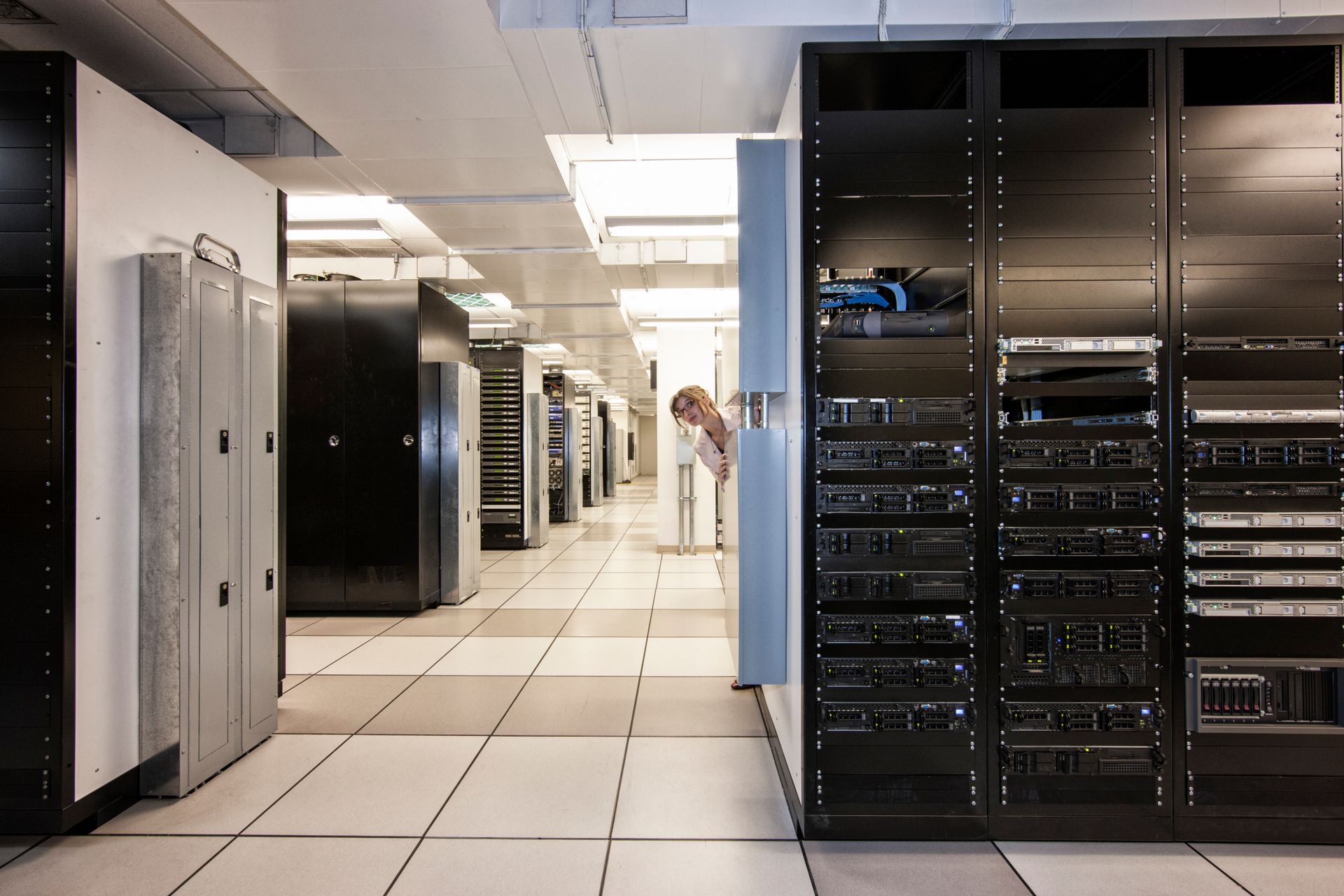 A row of servers are lined up in a server room