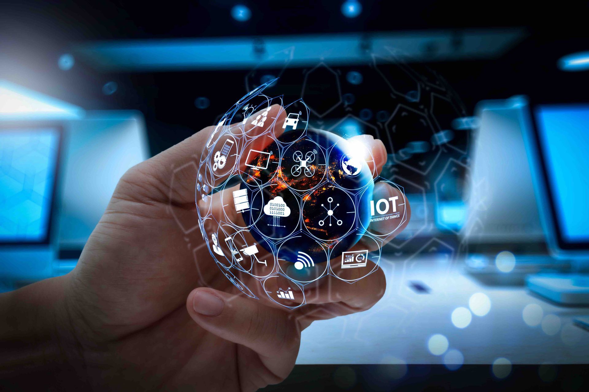 A person is holding a globe in their hand with icons on it.