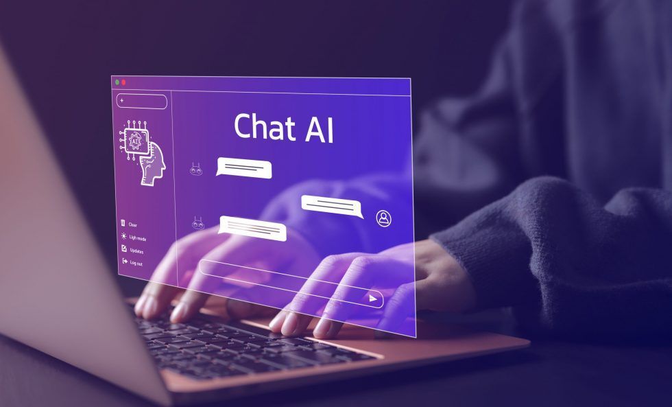 A person is typing on a laptop computer with a screen that says chat ai.