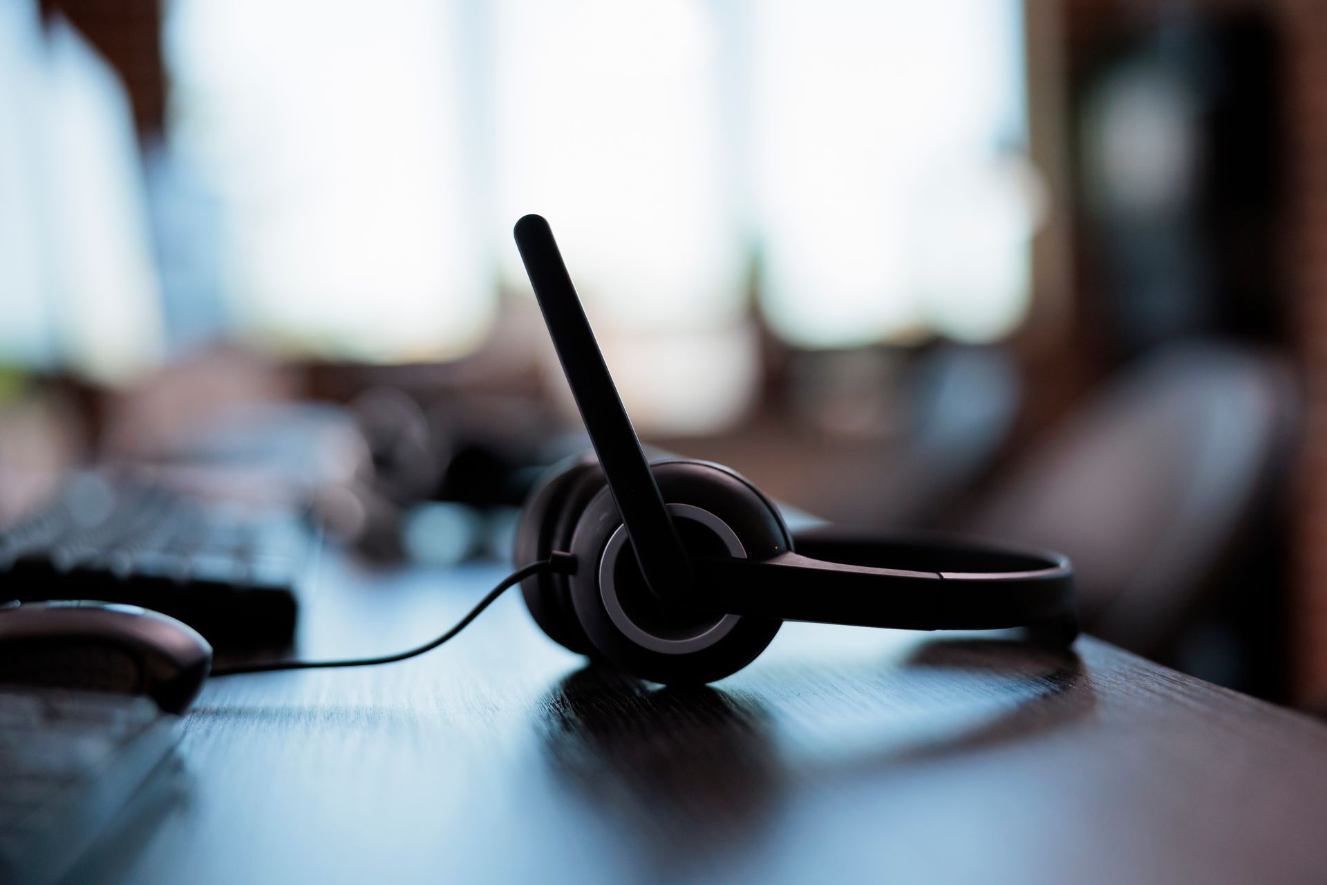 A close up of a headset with a microphone on a desk