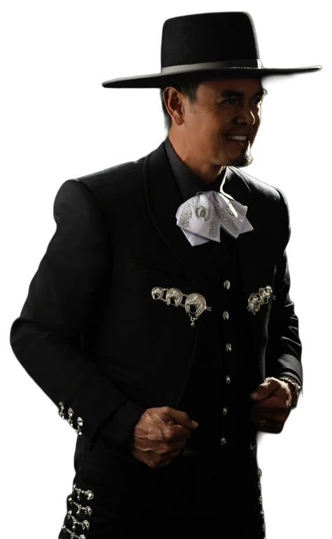 Man in a black charro suit with a wide-brimmed hat, smiling.
