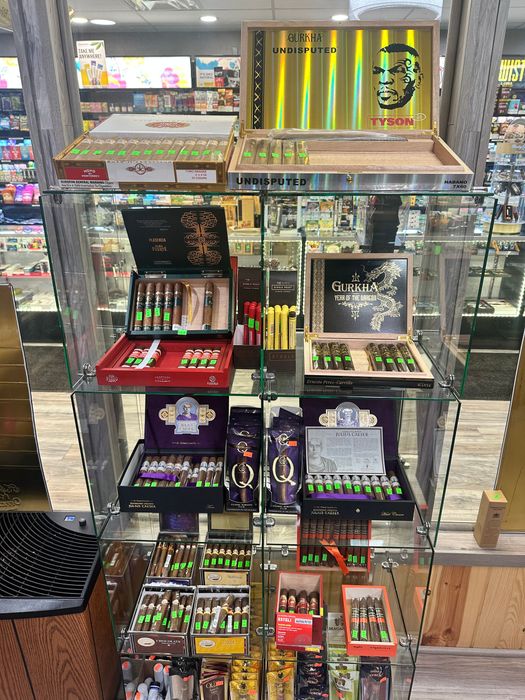 A display case filled with lots of different types of cigars.