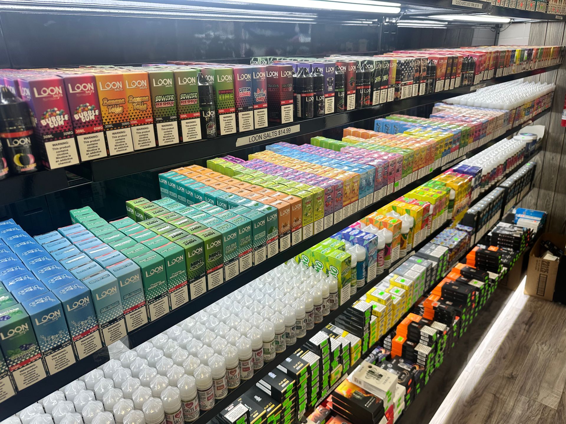 A shelf filled with lots of e liquids in a store.
