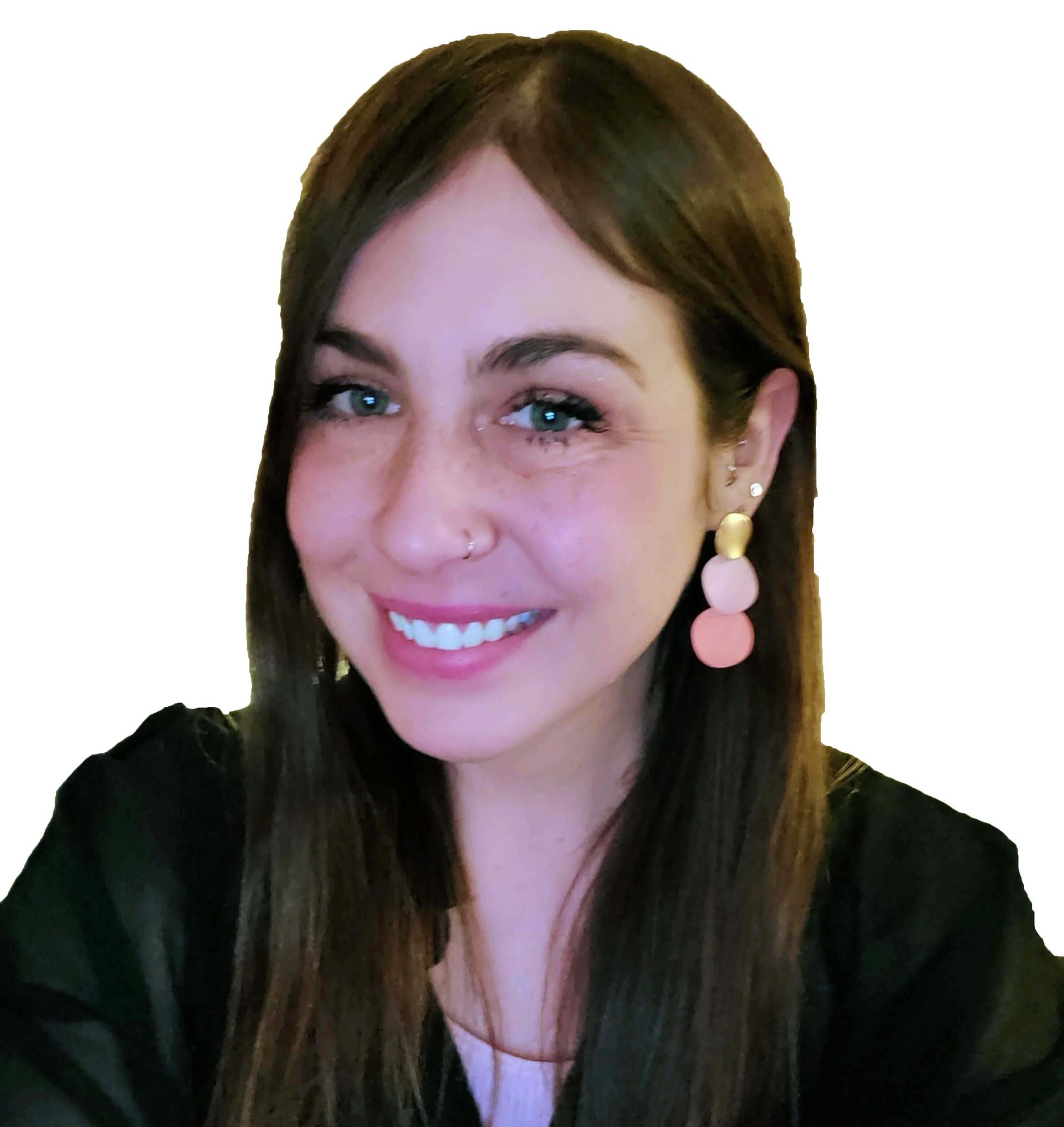 A woman wearing earrings and a nose ring smiles for the camera
