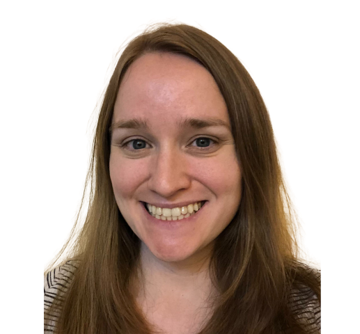 A woman with long brown hair is smiling for the camera