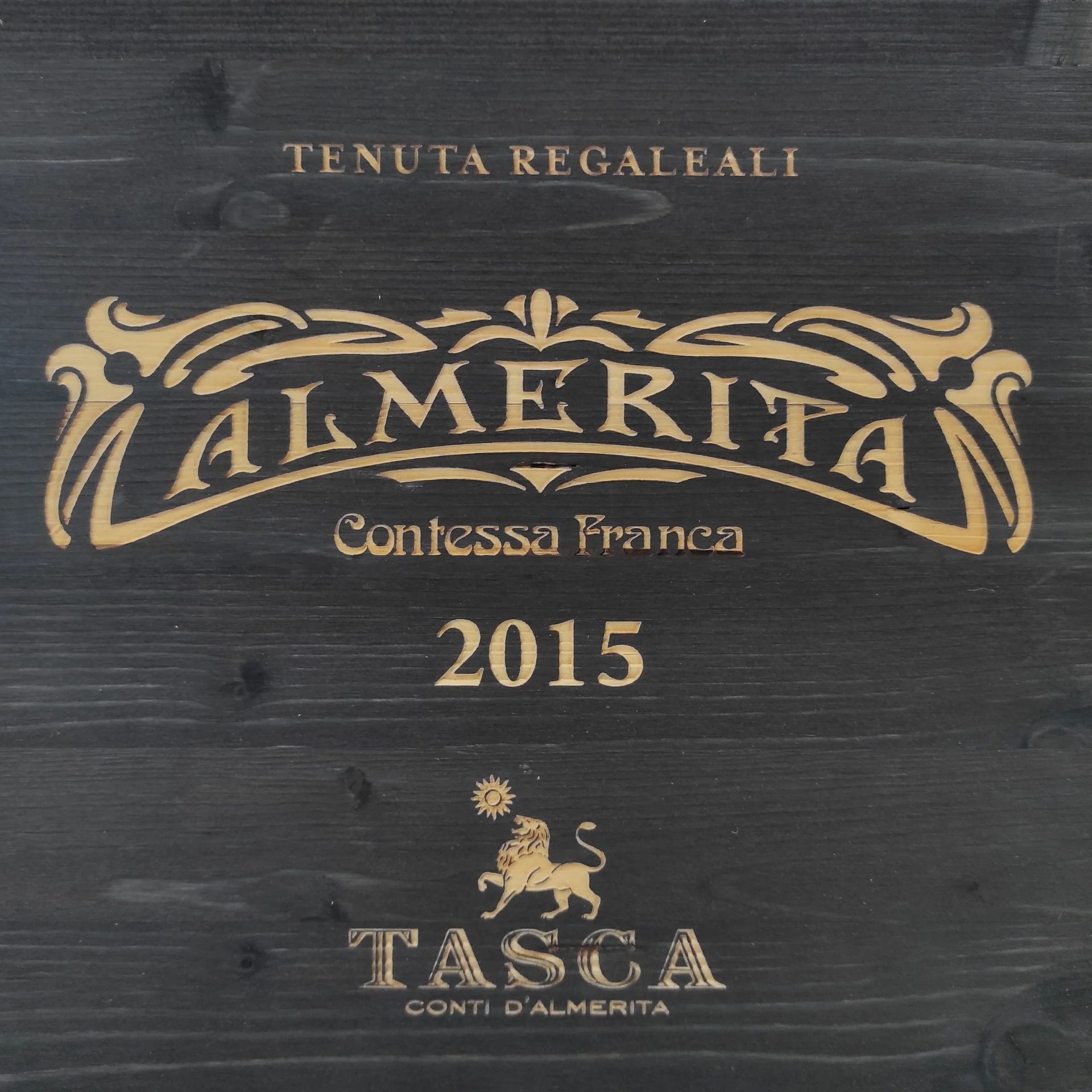 Black wine label with gold text: Almerita, Contessa Franca, 2015, Tasca, Tenuta Regaleali.