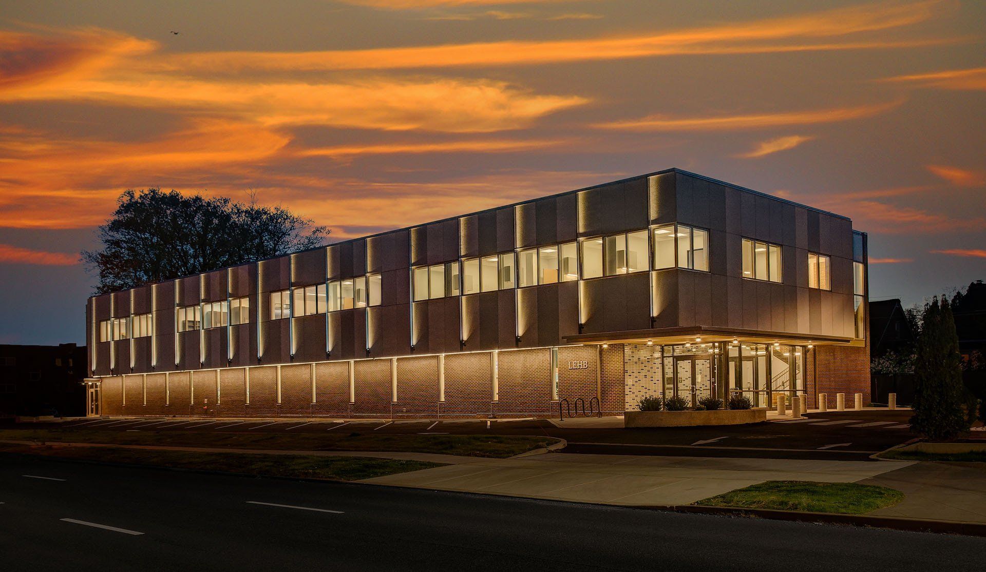A large building with a lot of windows is lit up at night.