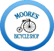 The logo for moore 's bicycle shop is a blue circle with a bicycle on it.