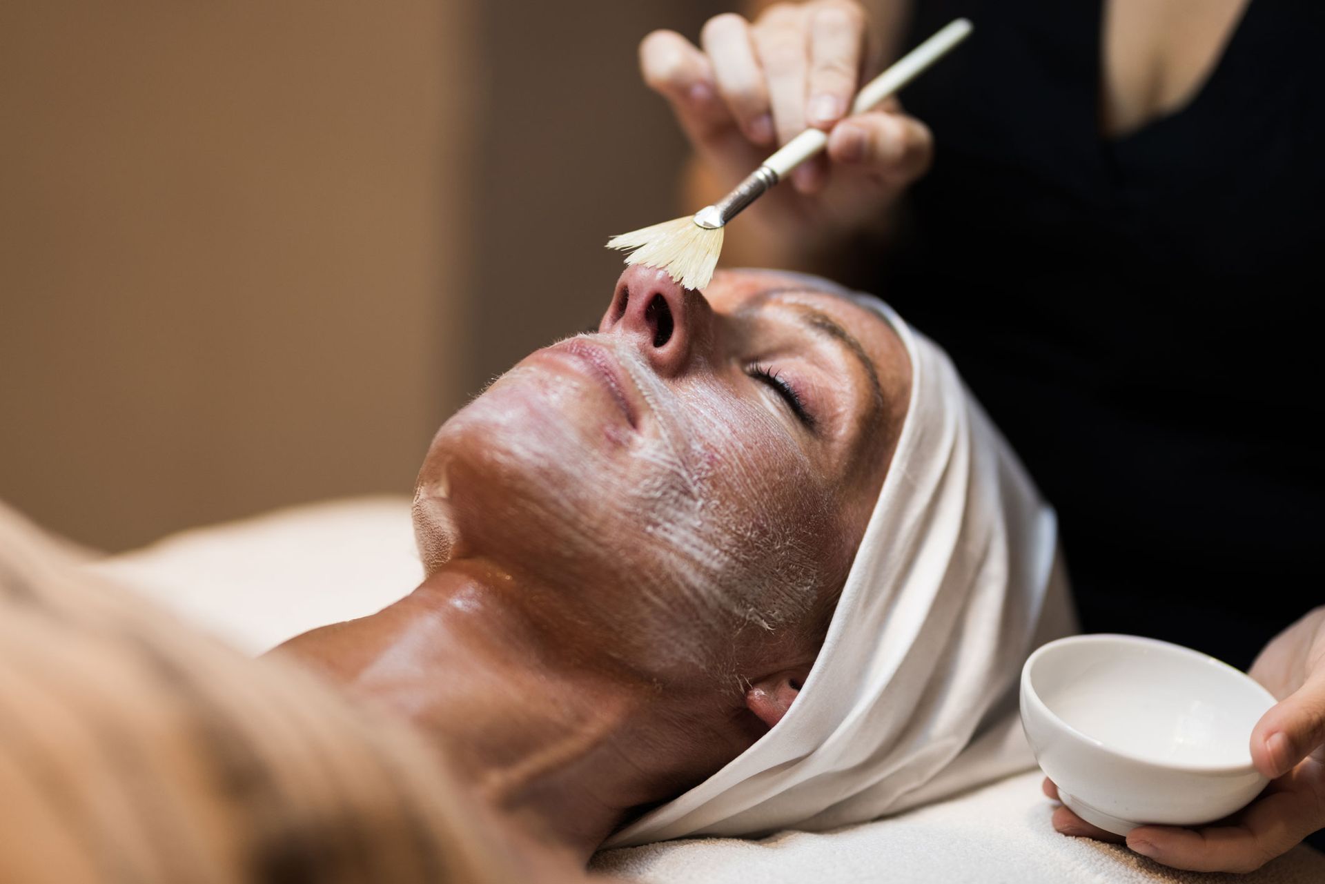 Woman in mask on face in spa beauty salon. Woman in mask on face in spa beauty salon.