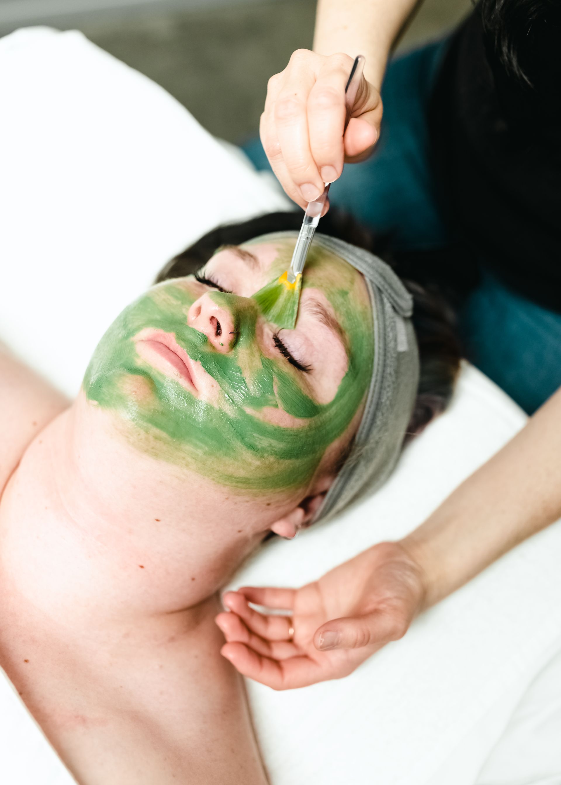 A young woman getting a European facial at a beauty spa