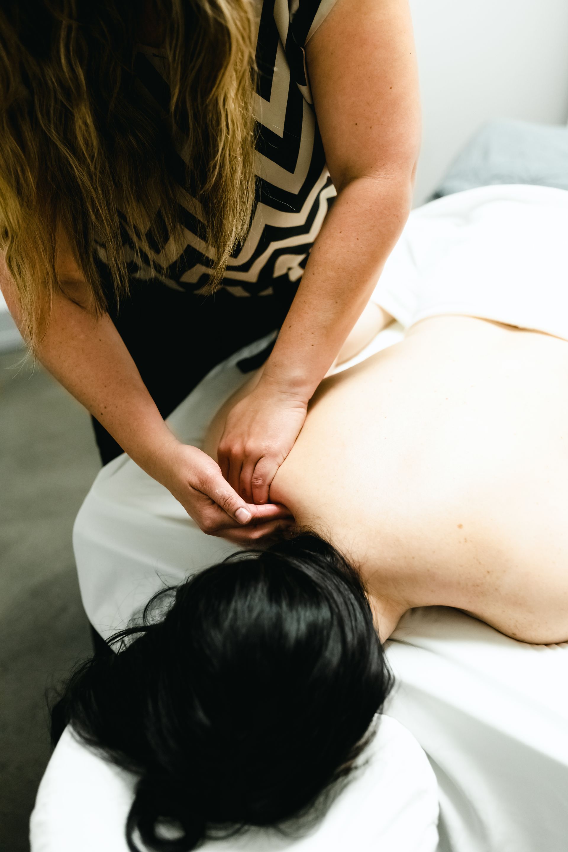 Picture of a woman getting a massage as part of a package of spa services she acquired
