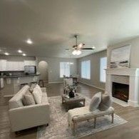 A living room filled with furniture and a fireplace.