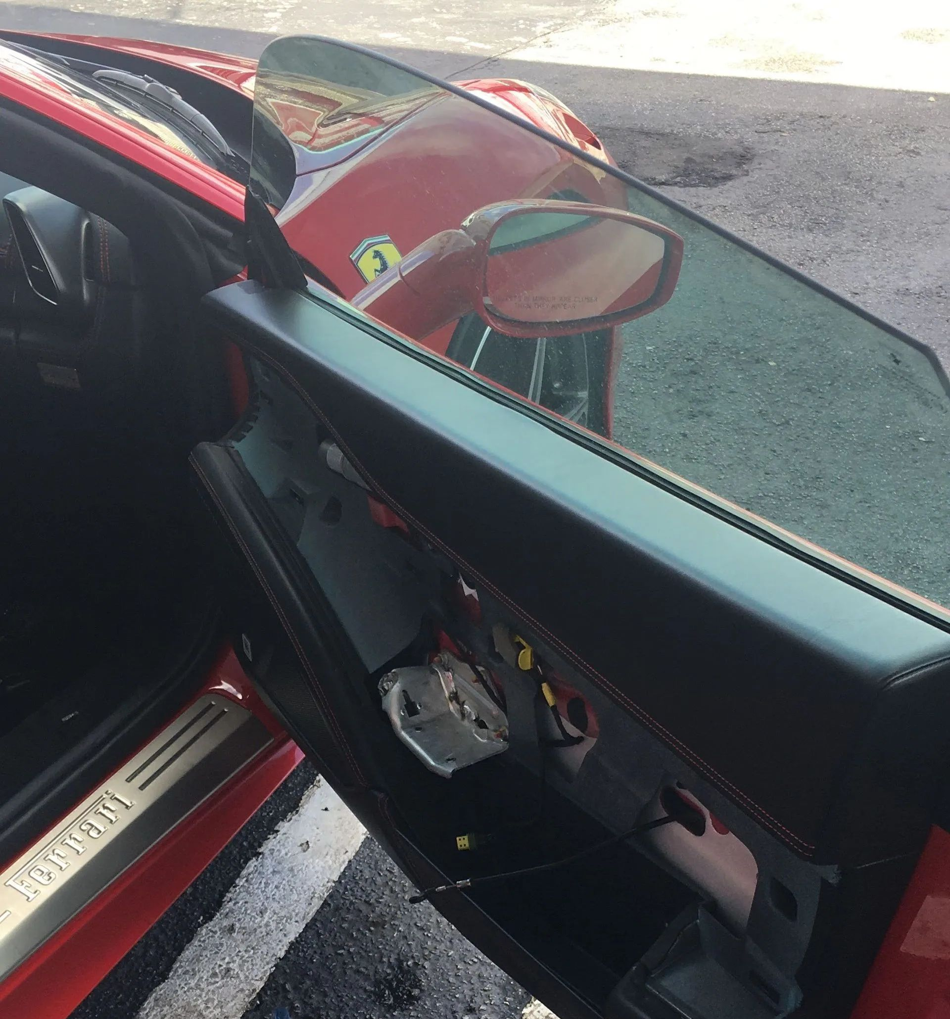 Damaged car interior with exposed door panel and broken trim after a collision