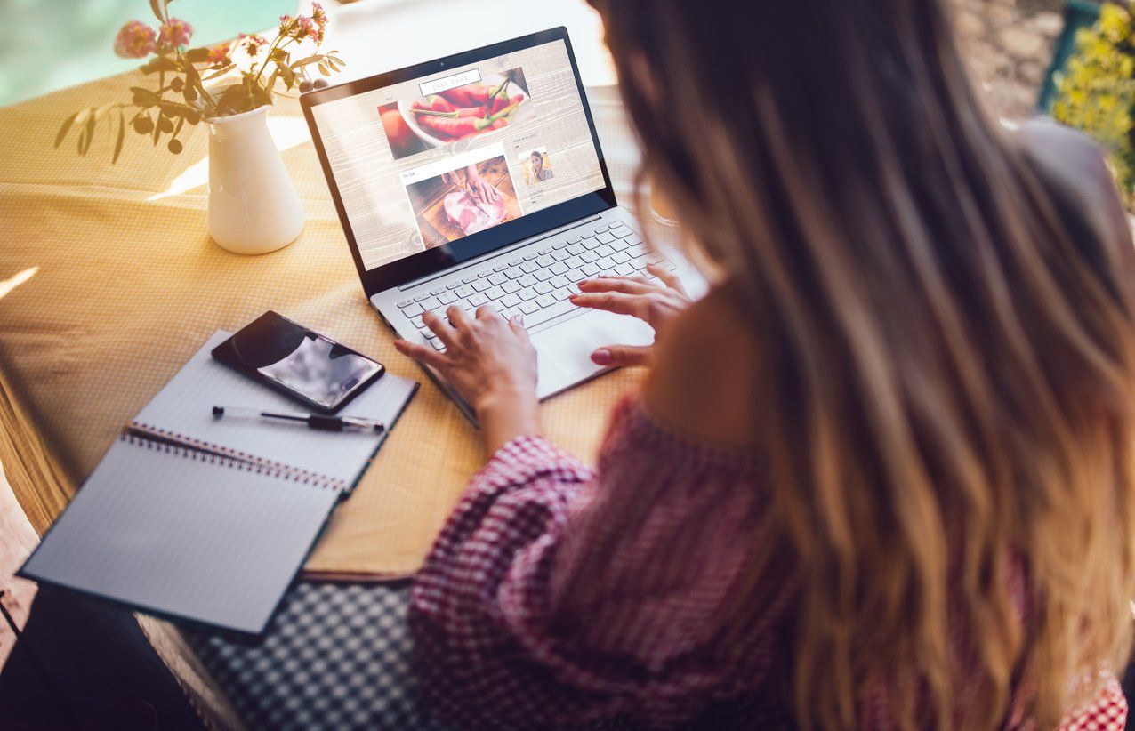 Female blogger working on a content using her laptop - digital businesses to start in 2023.