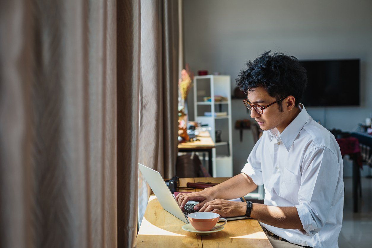 Man working on a laptop at home - taking projects and working in a gig economy.