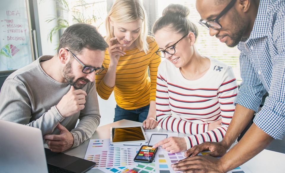Group of diverse website developers planning for a website's content and design.