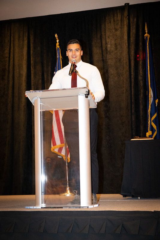 A man is standing at a podium giving a speech.