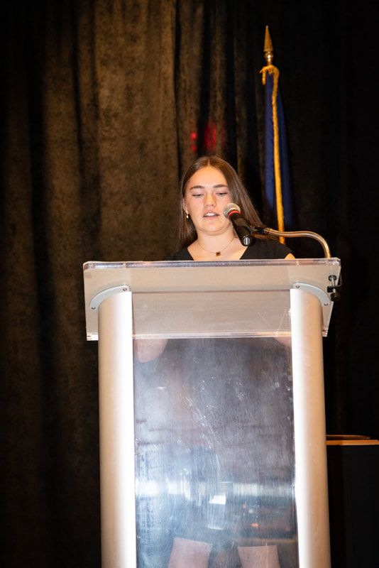 A woman is standing at a podium giving a speech.