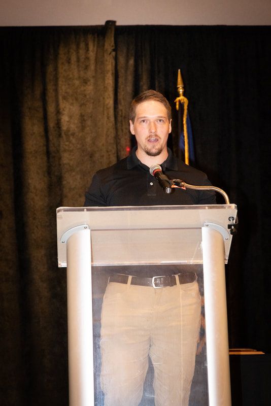 A man is standing at a podium giving a speech
