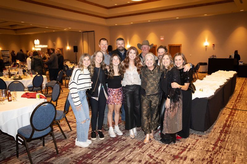 A group of people are posing for a picture in a room.