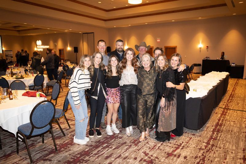A group of people are posing for a picture in a room.