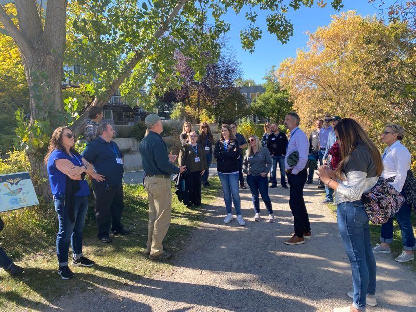 A group of people are standing in a circle on a path.