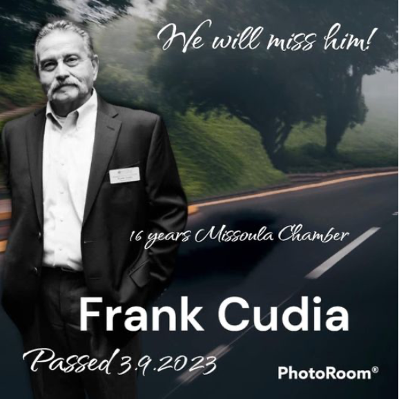 A man in a suit is standing on a road with the words we will miss him