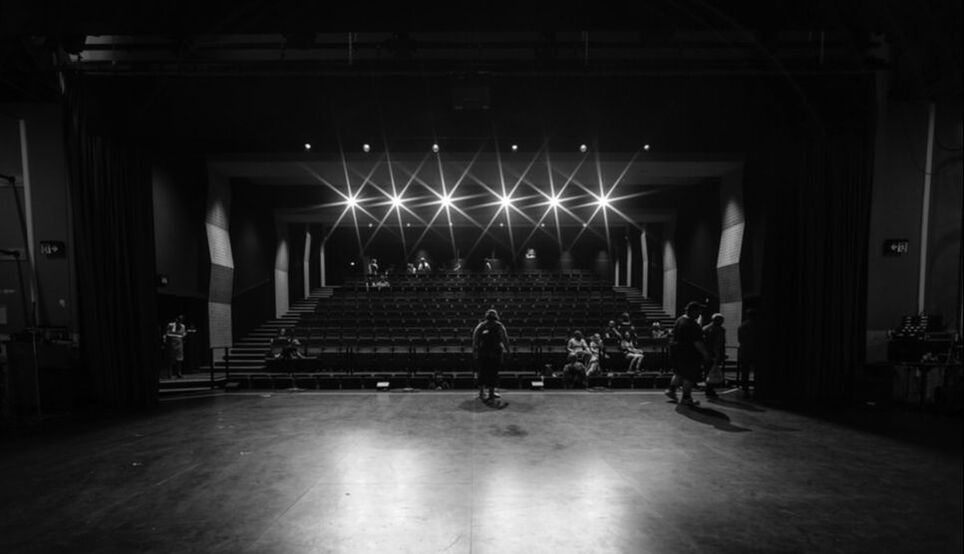 A black and white photo of a stage in a theater