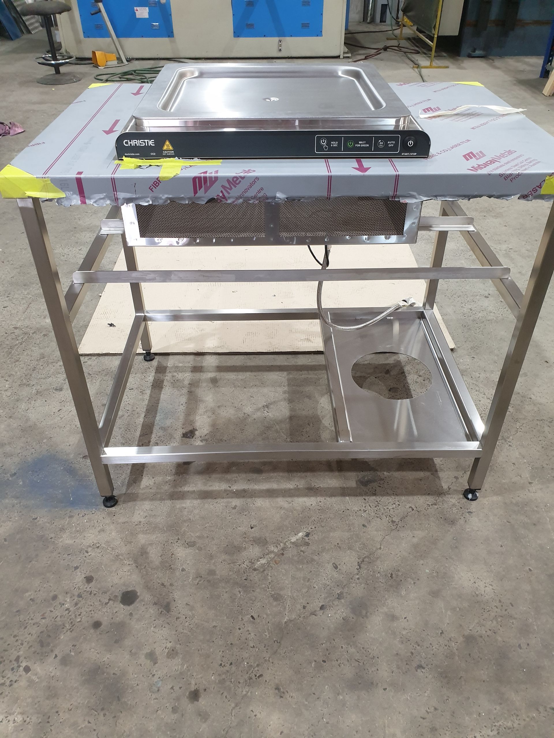 A stainless steel table with a stove on top of it.