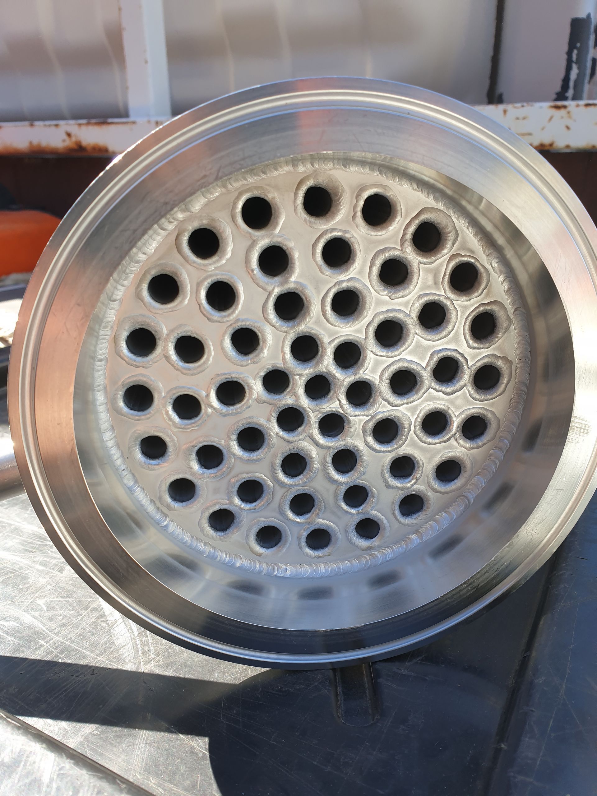 A close up of a metal pipe with holes in it