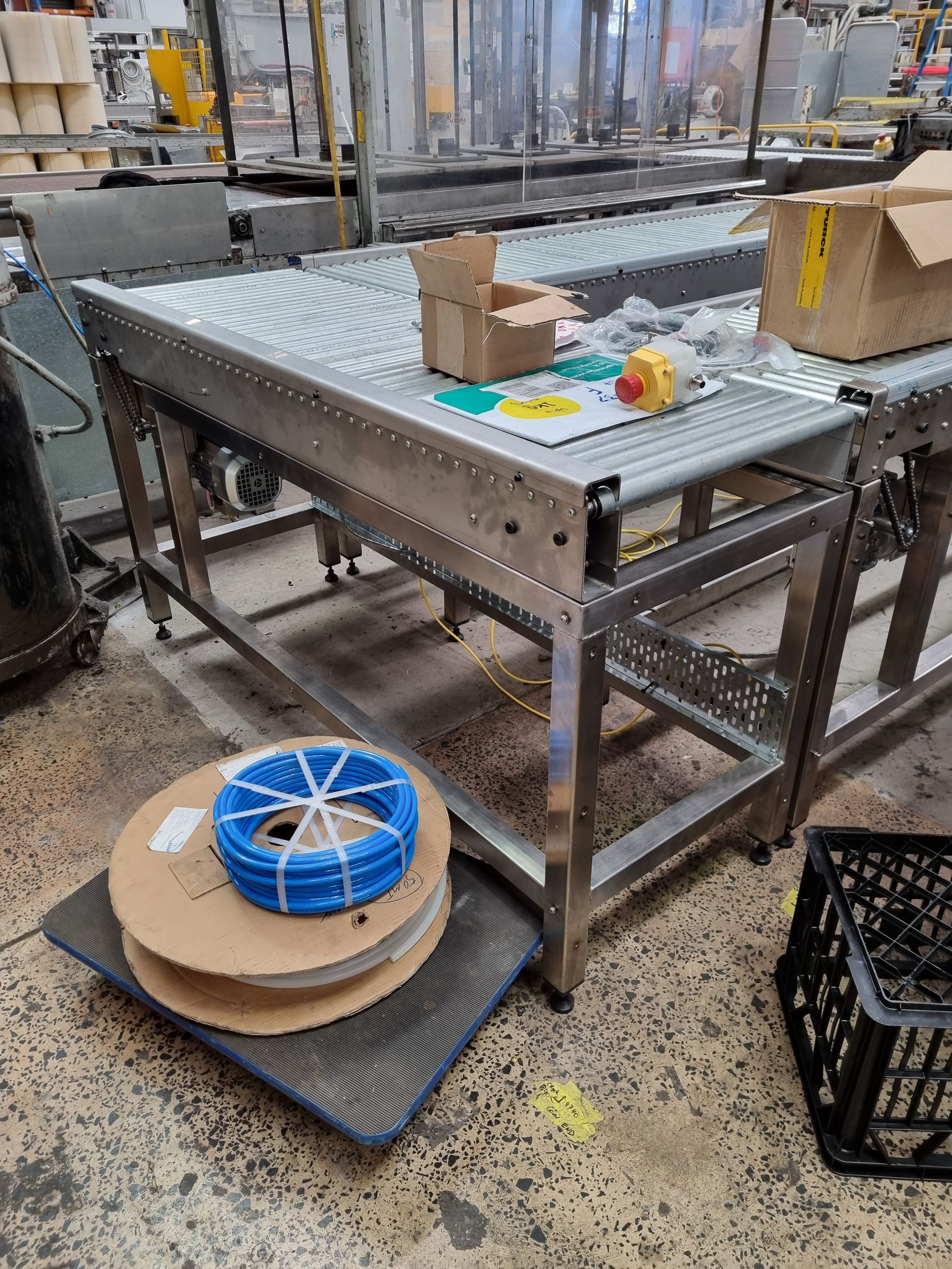 A conveyor belt is sitting on top of a table in a factory.