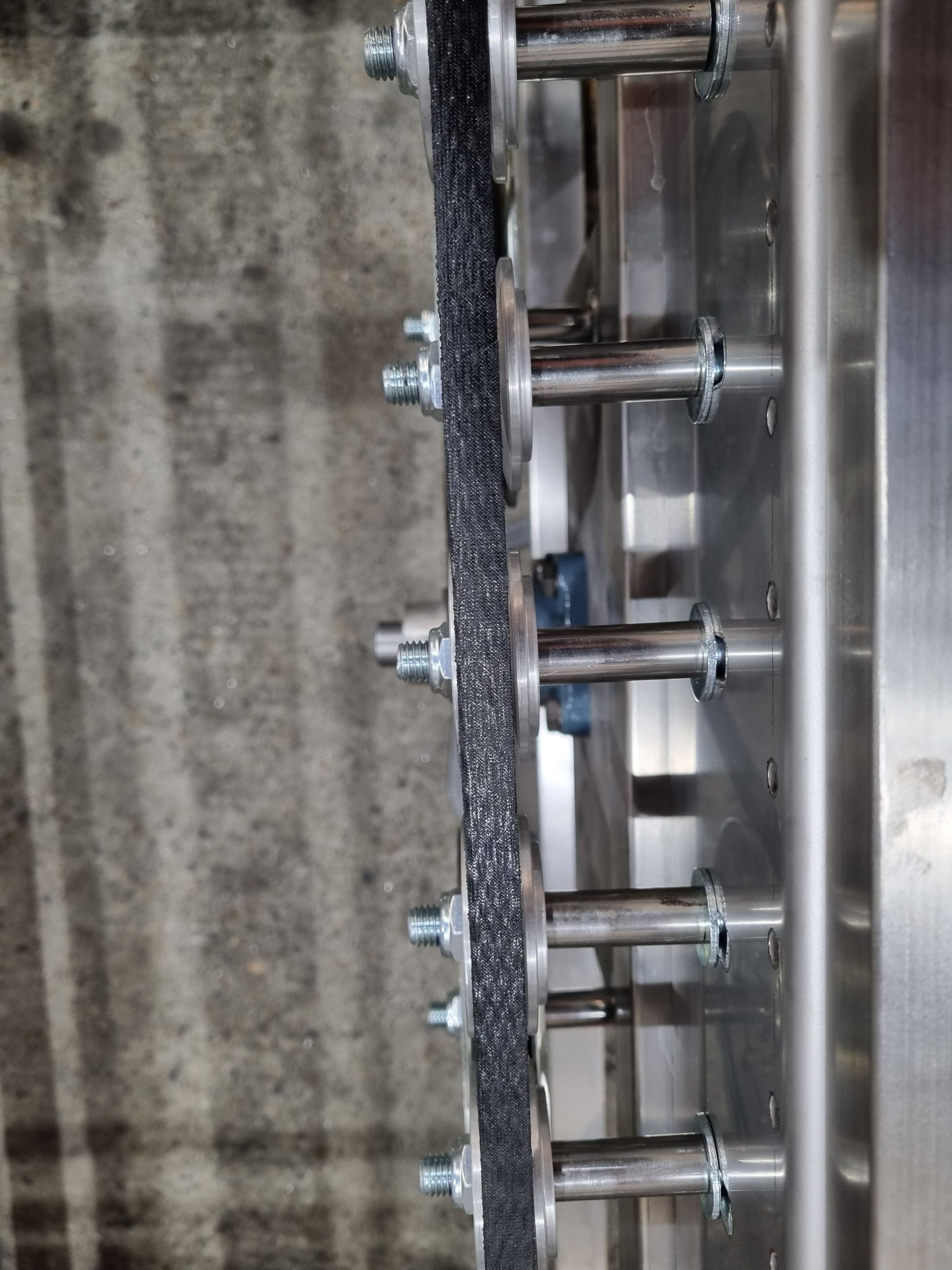 A close up of a metal object with screws on it.
