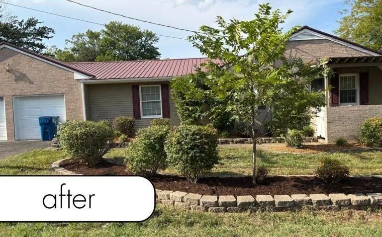 Single-story brick house with red roof, shrubs, and young tree in front yard; 