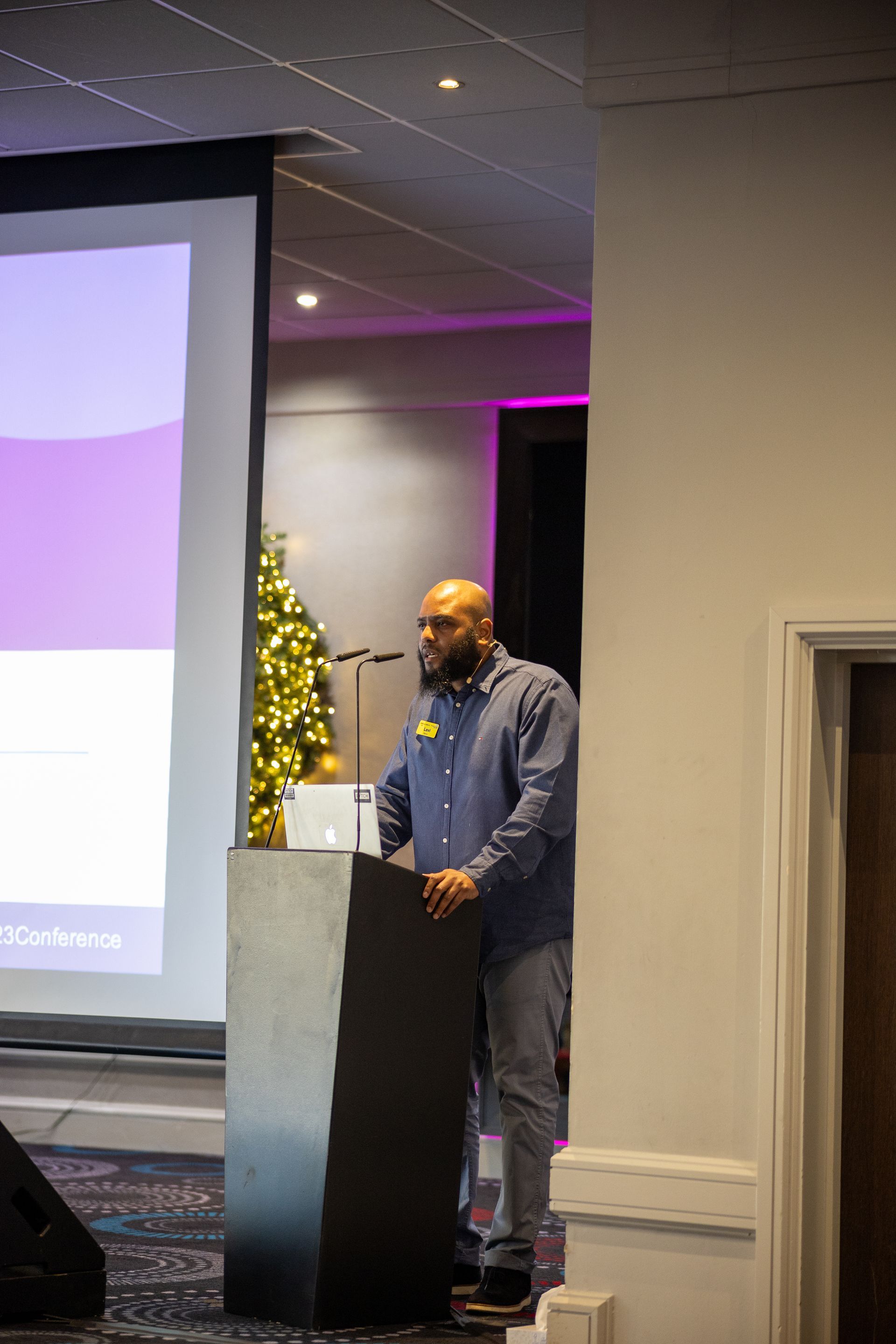 A man is standing at a podium giving a presentation.