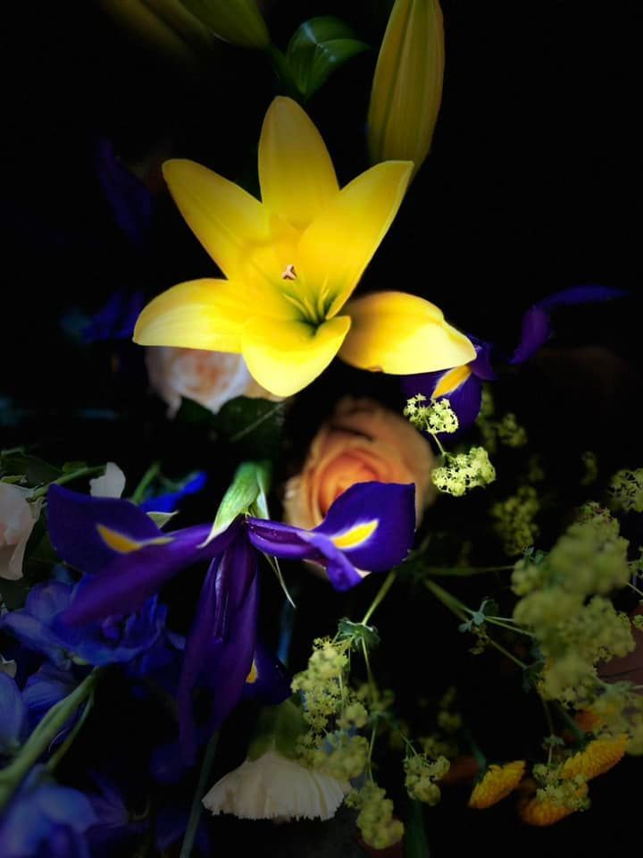 A bouquet of flowers with a yellow flower in the middle